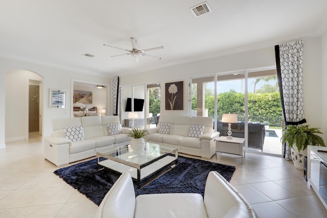 12479 Aviles Cir, Palm Beach Gardens, FL 33418 - living room with a ceiling fan, light tile patterned floors, arched walkways, ornamental molding, and baseboards