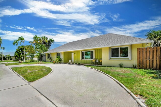 3412 Lake Osborne Dr, Lake Worth Beach, FL 33461 - kitchen with gray cabinetry, appliances with stainless steel finishes, a breakfast bar, a textured ceiling, and tasteful backsplash