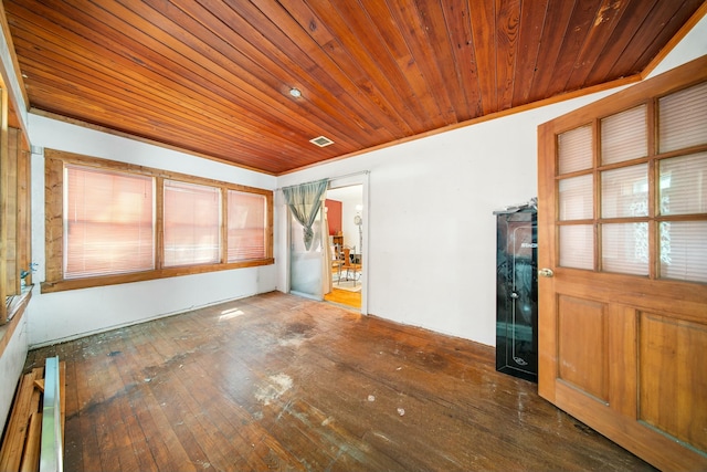 unfurnished room featuring wood-type flooring, wooden ceiling, and visible vents
