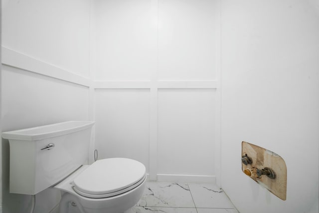 bathroom with marble finish floor and toilet