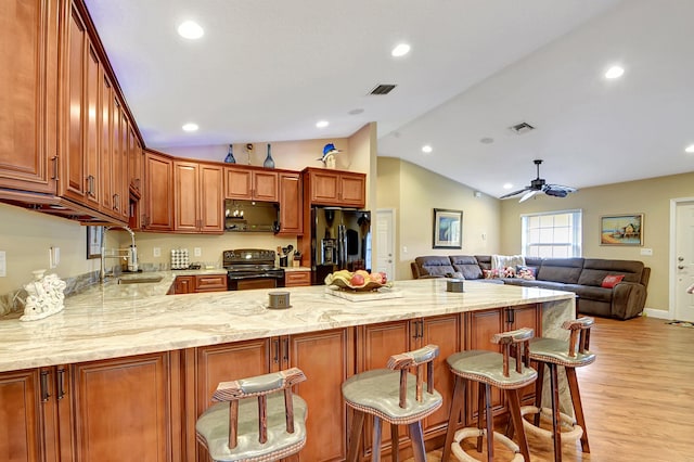 16181 90th St N, Loxahatchee, FL 33470 - kitchen with visible vents, a peninsula, ceiling fan, a sink, and black appliances