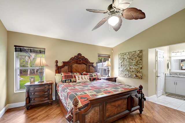16181 90th St N, Loxahatchee, FL 33470 - bedroom with baseboards, a sink, light wood finished floors, ensuite bath, and vaulted ceiling