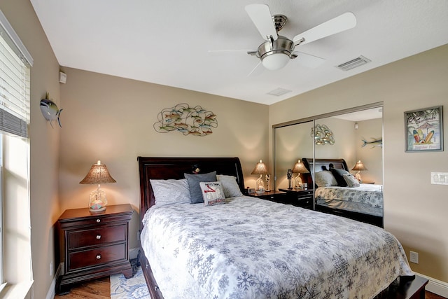 16181 90th St N, Loxahatchee, FL 33470 - bedroom with ceiling fan, visible vents, wood finished floors, and a closet