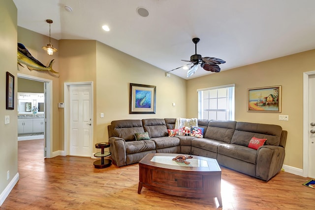 16181 90th St N, Loxahatchee, FL 33470 - living area featuring light wood-style floors, baseboards, ceiling fan, and vaulted ceiling