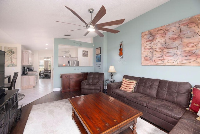 3381 SE E Snow Rd, Port Saint Lucie, FL 34984 - living room featuring lofted ceiling, a textured ceiling, dark wood-style flooring, and a ceiling fan
