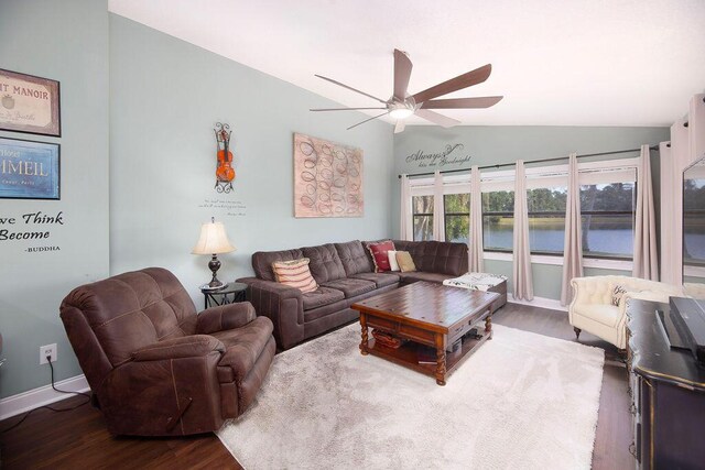 3381 SE E Snow Rd, Port Saint Lucie, FL 34984 - living area featuring lofted ceiling, a water view, baseboards, a ceiling fan, and wood finished floors