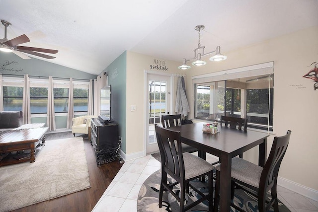 3381 SE E Snow Rd, Port Saint Lucie, FL 34984 - dining room featuring a ceiling fan, light tile patterned flooring, baseboards, and vaulted ceiling
