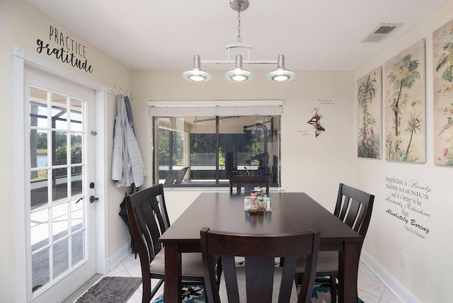 3381 SE E Snow Rd, Port Saint Lucie, FL 34984 - dining area with light tile patterned floors, a healthy amount of sunlight, and visible vents