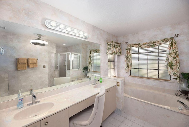 3381 SE E Snow Rd, Port Saint Lucie, FL 34984 - full bathroom featuring tile patterned flooring, a shower stall, a sink, a garden tub, and double vanity