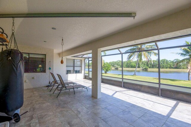 3381 SE E Snow Rd, Port Saint Lucie, FL 34984 - unfurnished sunroom with a water view and a healthy amount of sunlight