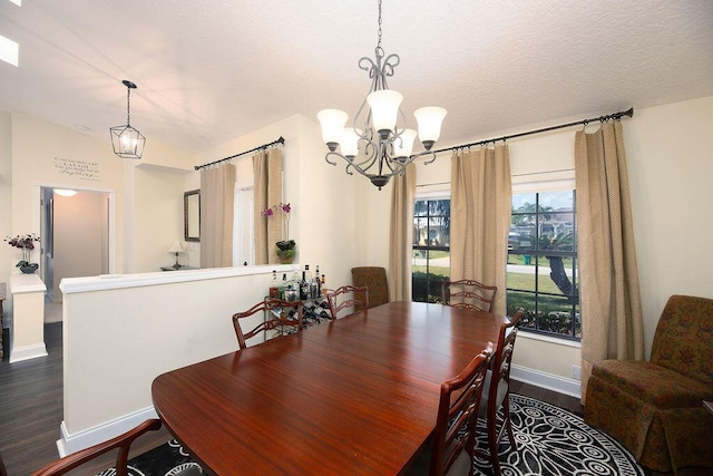 3381 SE E Snow Rd, Port Saint Lucie, FL 34984 - dining space featuring a textured ceiling, baseboards, dark wood finished floors, lofted ceiling, and an inviting chandelier