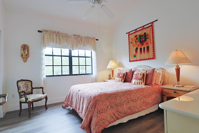bedroom featuring baseboards, a ceiling fan, lofted ceiling, and wood finished floors