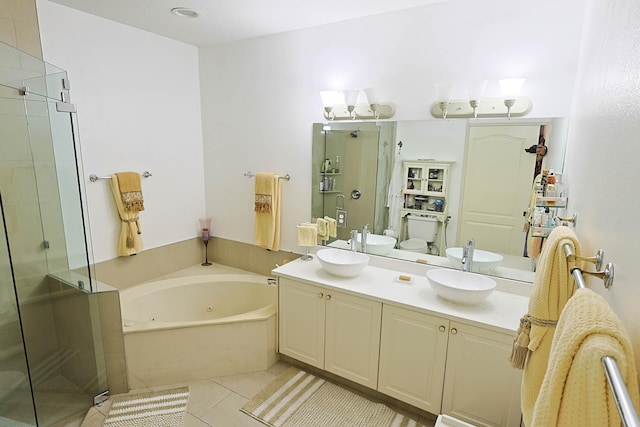 full bath featuring a sink, double vanity, tile patterned floors, a whirlpool tub, and a stall shower