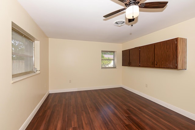 1034 Grandview Blvd, Fort Pierce, FL 34982 - spare room with visible vents, ceiling fan, dark wood-style flooring, and baseboards