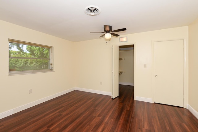 1034 Grandview Blvd, Fort Pierce, FL 34982 - unfurnished bedroom featuring a spacious closet, a closet, dark wood-style flooring, baseboards, and visible vents