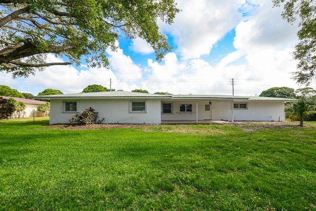 1034 Grandview Blvd, Fort Pierce, FL 34982 - back of property with a patio, stucco siding, and a yard