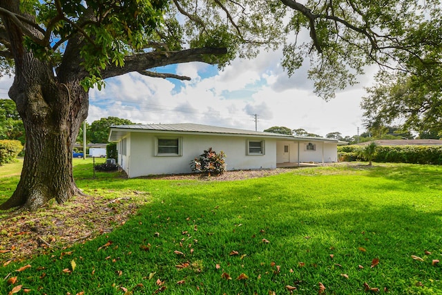 1034 Grandview Blvd, Fort Pierce, FL 34982 - rear view of house with a yard and stucco siding