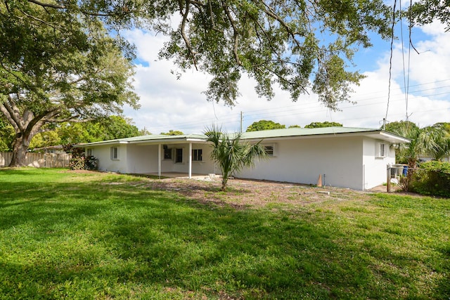 1034 Grandview Blvd, Fort Pierce, FL 34982 - rear view of property featuring a yard and fence