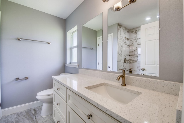 bathroom featuring vanity, marble finish floor, a shower, baseboards, and toilet