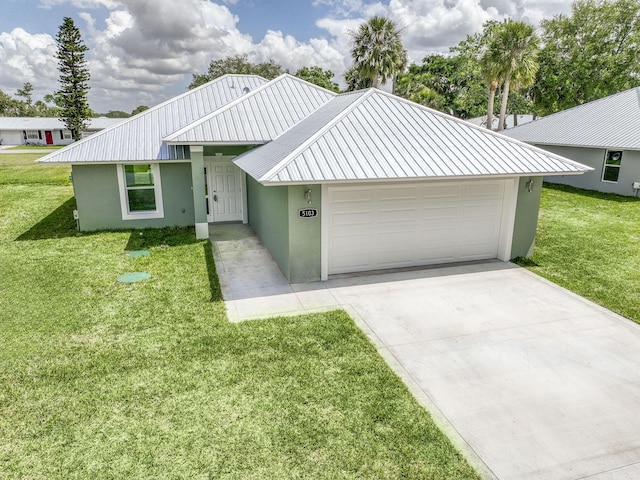 ranch-style house featuring a garage, a front yard, and stucco siding