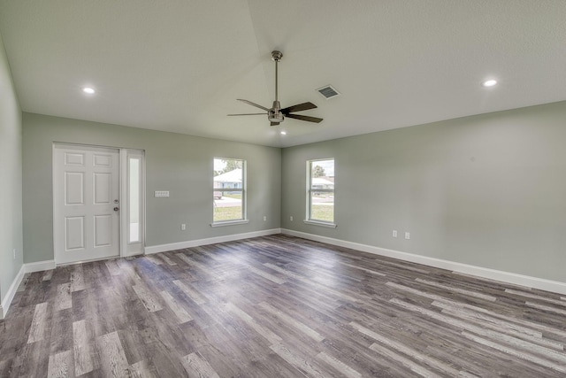 interior space with baseboards, a ceiling fan, wood finished floors, and recessed lighting