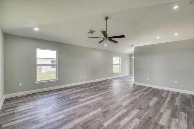 spare room featuring recessed lighting, wood finished floors, visible vents, baseboards, and ceiling fan