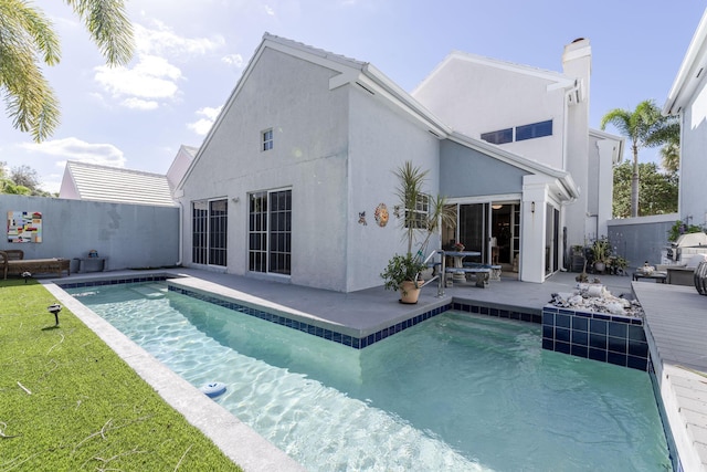 41 Windsor Ln, Palm Beach Gardens, FL 33418 - back of house featuring a patio area, stucco siding, and a chimney