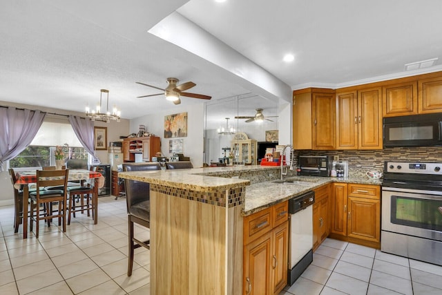 kitchen with black microwave, stainless steel electric range oven, a sink, dishwashing machine, and a ceiling fan