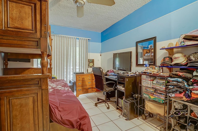 home office featuring light tile patterned flooring, a textured ceiling, and ceiling fan