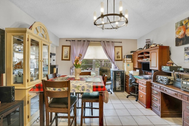 dining room with wine cooler, a chandelier, a textured ceiling, an office area, and light tile patterned flooring