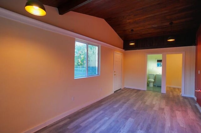 empty room featuring wood ceiling, vaulted ceiling with beams, and wood finished floors