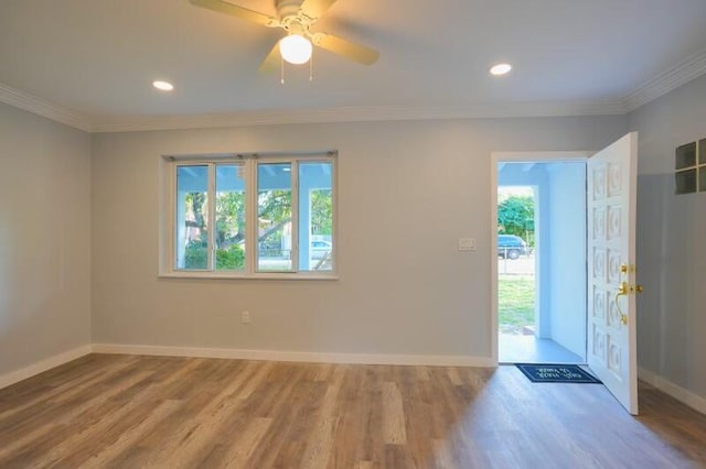 entryway with baseboards, crown molding, wood finished floors, and recessed lighting