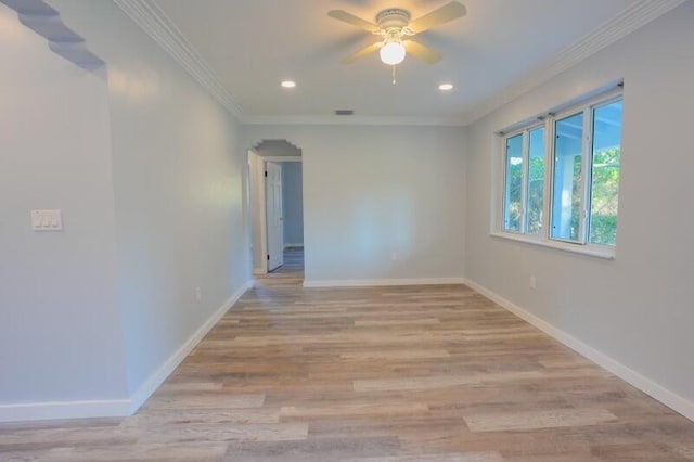 unfurnished room featuring baseboards, crown molding, light wood-style flooring, and a ceiling fan