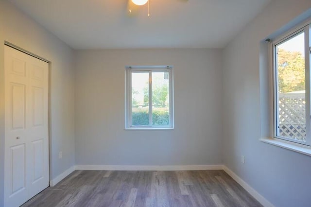 unfurnished bedroom with baseboards and wood finished floors