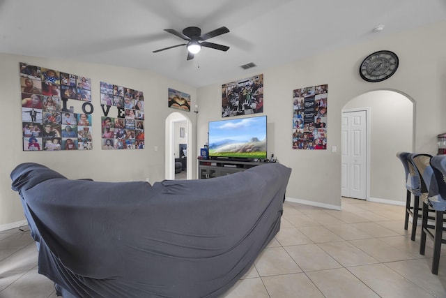 6116 NW Daroco Ter, Port Saint Lucie, FL 34986 - living room with ceiling fan, arched walkways, baseboards, light tile patterned floors, and visible vents