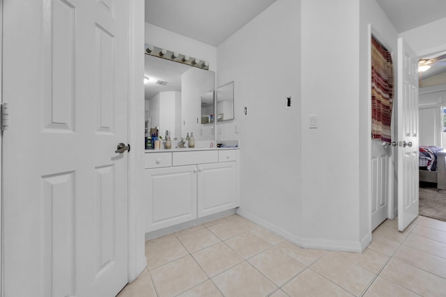6116 NW Daroco Ter, Port Saint Lucie, FL 34986 - ensuite bathroom featuring tile patterned flooring, baseboards, ensuite bathroom, and vanity