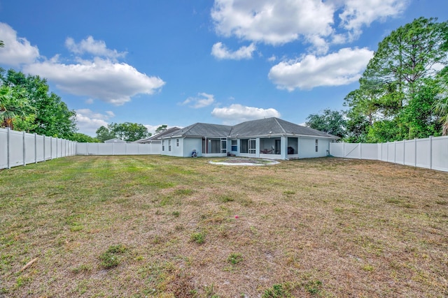 6116 NW Daroco Ter, Port Saint Lucie, FL 34986 - rear view of house with a lawn and a fenced backyard