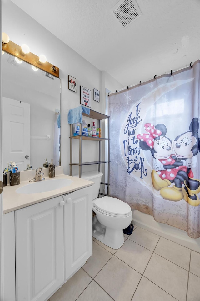6116 NW Daroco Ter, Port Saint Lucie, FL 34986 - full bathroom with vanity, tile patterned flooring, toilet, and visible vents