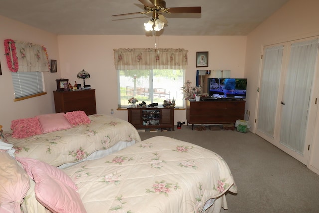 bedroom featuring carpet floors, lofted ceiling, and ceiling fan