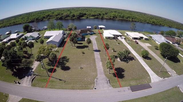 birds eye view of property featuring a water view and a forest view