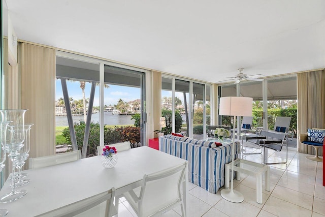 sunroom featuring a water view