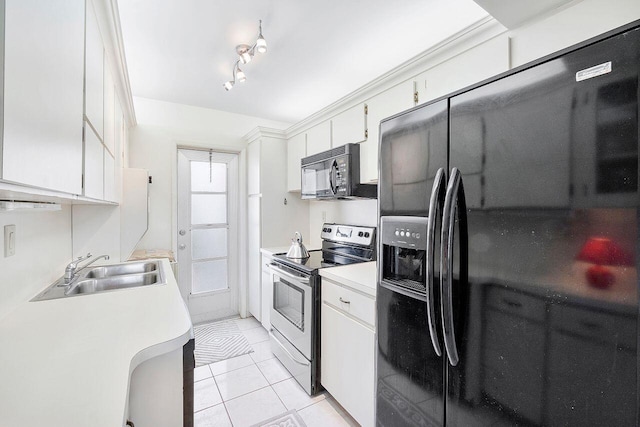 kitchen with black appliances, light countertops, a sink, and light tile patterned floors
