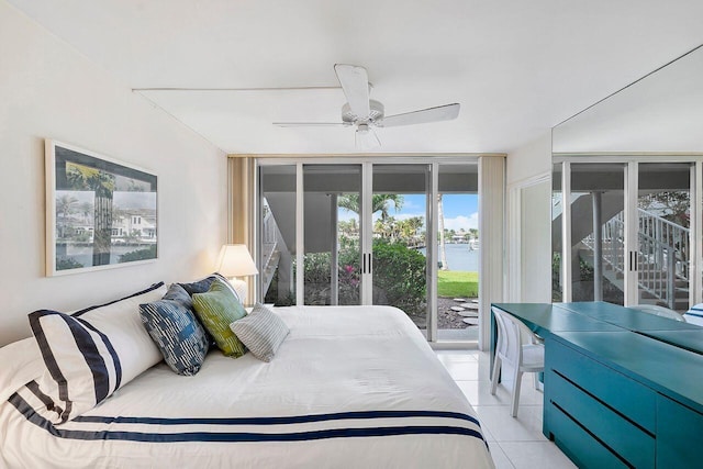 bedroom featuring light tile patterned flooring, access to exterior, floor to ceiling windows, and a ceiling fan