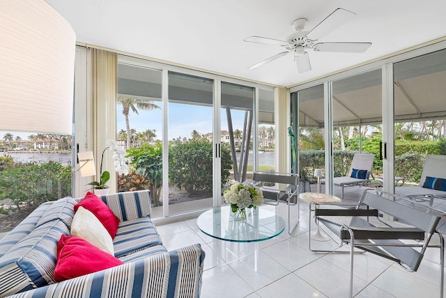 sunroom with expansive windows, an outdoor hangout area, ceiling fan, and tile patterned flooring