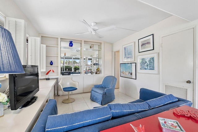 living area with tile patterned floors, ceiling fan, and visible vents