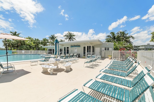pool featuring fence and a patio