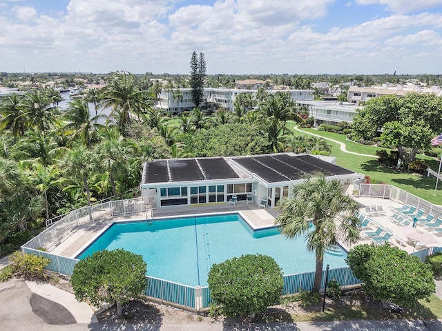 community pool featuring fence and a patio area