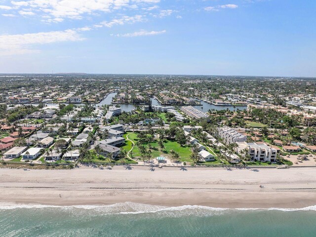 drone / aerial view with a beach view and a water view
