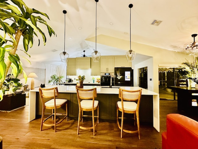 9494 Sun Pointe Dr, Boynton Beach, FL 33437 - bar area with black fridge, decorative light fixtures, wood finished floors, double oven, and vaulted ceiling