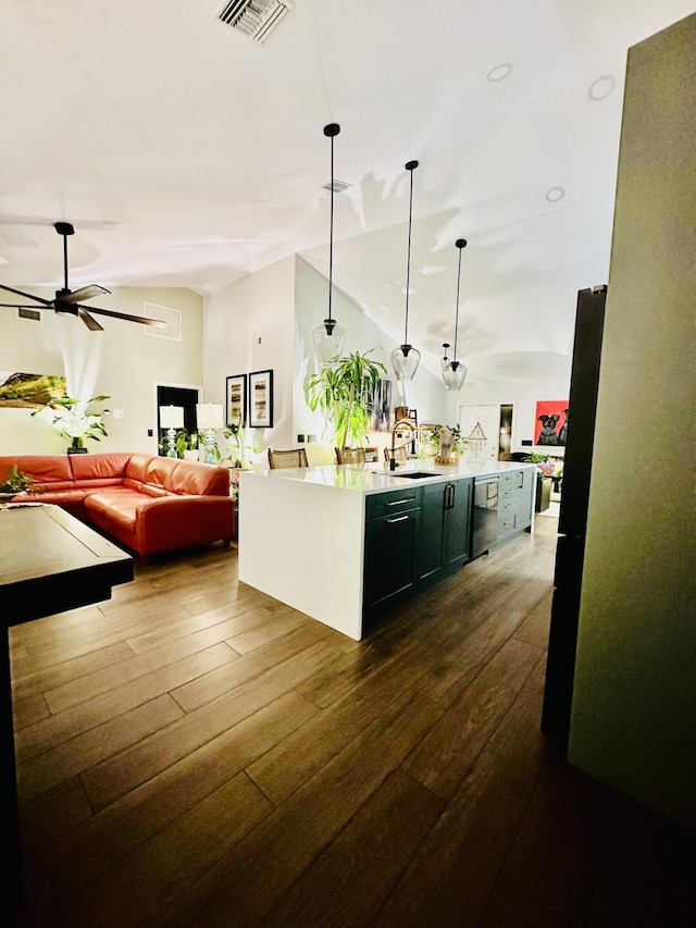 9494 Sun Pointe Dr, Boynton Beach, FL 33437 - kitchen featuring a sink, dark wood-style floors, light countertops, open floor plan, and a center island with sink